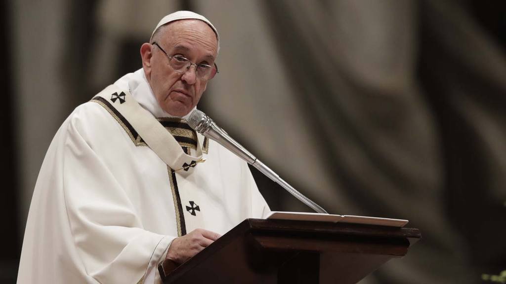 Pope Francis reads his homily as he celebrates the Christmas Eve Mass
